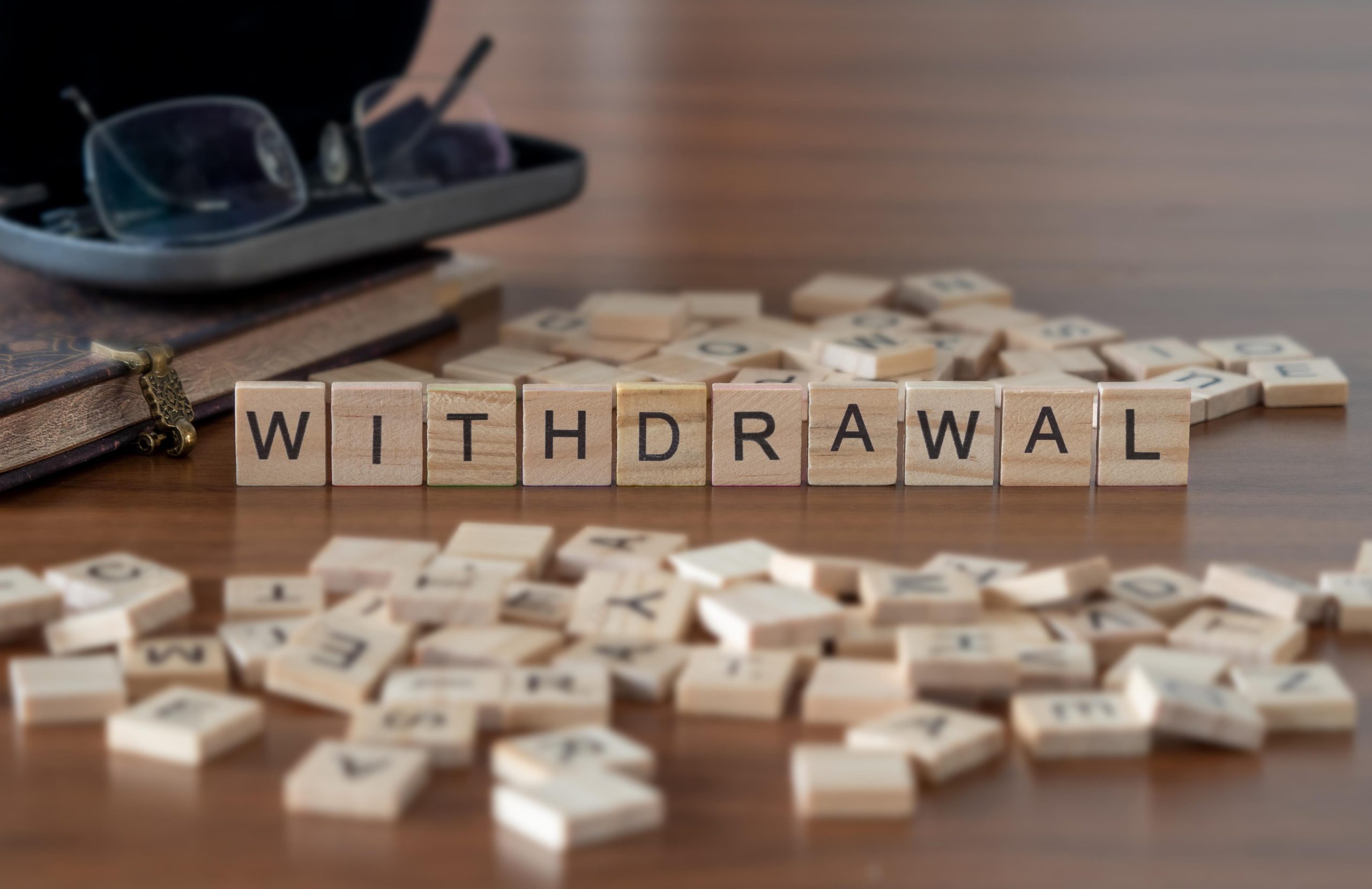 Withdrawal,Concept,Represented,By,Wooden,Letter,Tiles
