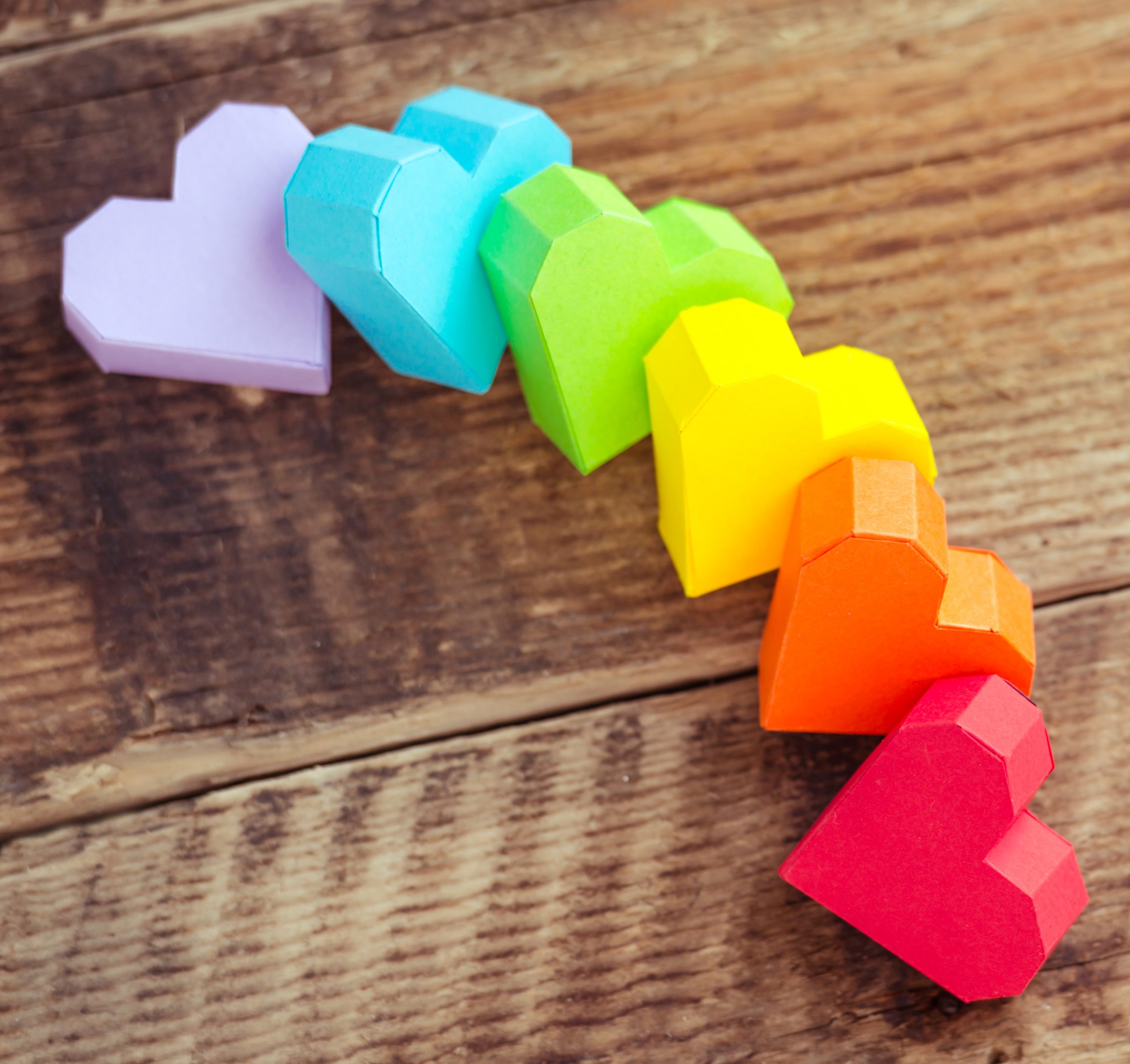 Bright,Paper,Hearts,On,Wooden,Background