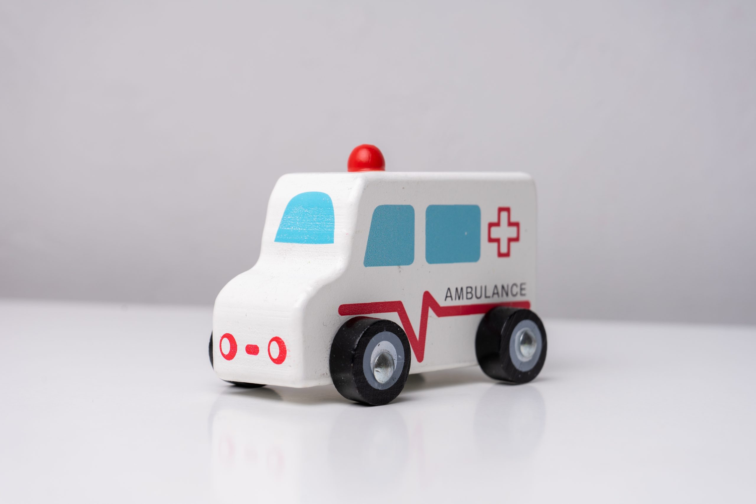 Wooden,Ambulance,Toy,Car,On,White,Table