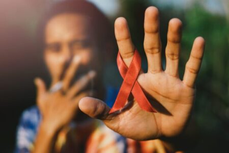 Red,Aids,Ribbon,In,Hand.